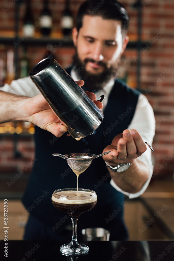 close up of barman preparing espresso martini cocktail