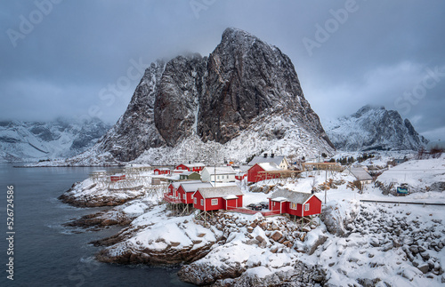 Snow on lofoten island with red houses and mountains in winter norway