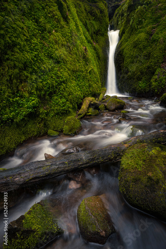 beautiful waterfall with moss covered rocks © Peter