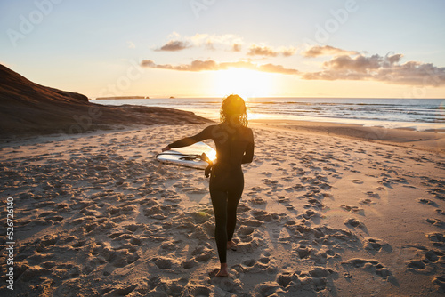 Photography Strong gorgeous surfer woman walking through the sandy beach with her surfboard