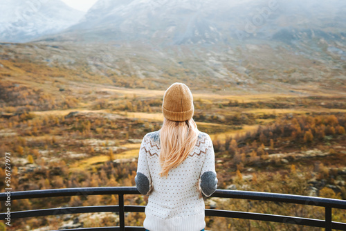 Autumn travel outdoor woman looking at view forest and mountains in Norway healthy lifestyle sweater and hat clothing cold scandinavian weather tourist exploring Jotunheimen park