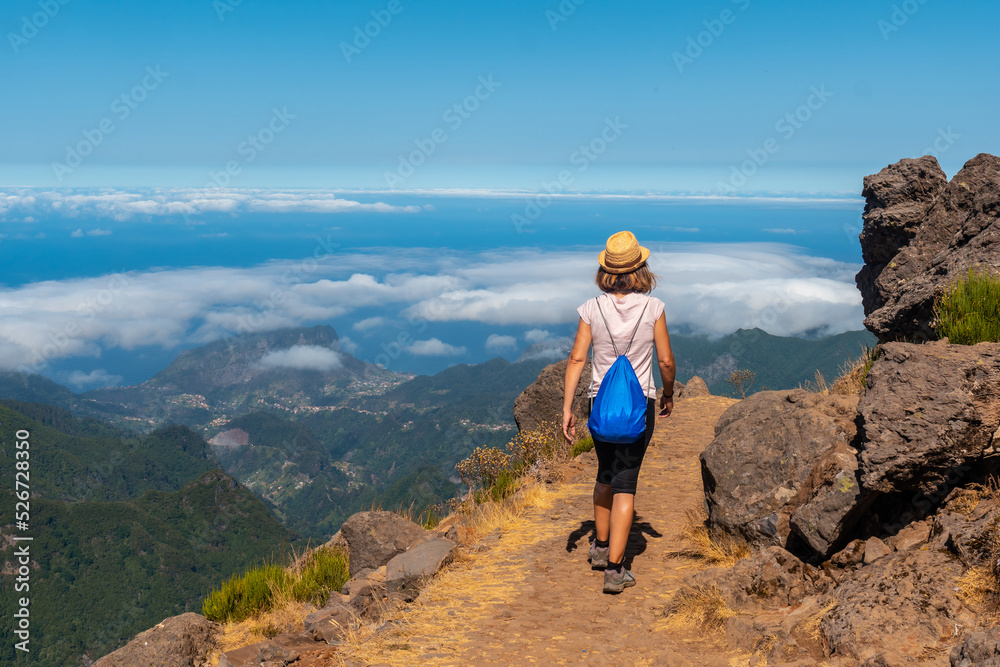 A young woman strolling at the Miradouro do Juncal on Pico do Arieiro, Madeira. Portugal