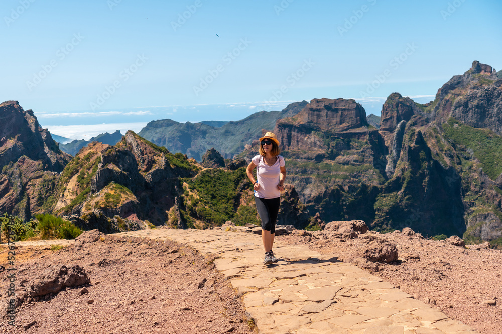 A tourist walking on the trekking trail at Pico do Arieiro, Madeira. Portugal