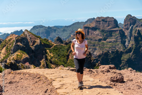 A tourist walking on the trekking trail at Pico do Arieiro in summer, Madeira. Portugal