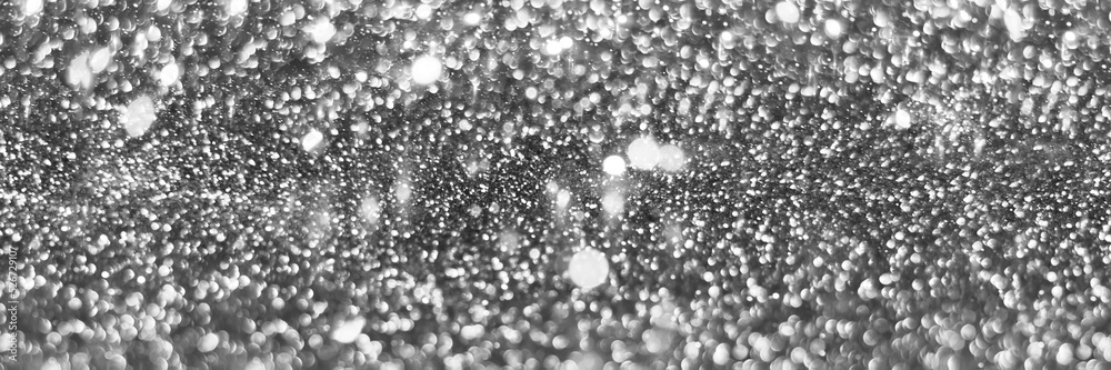 Gray silver sparkling glitter bokeh background, christmas abstract defocused texture. Holiday lights. Snowy shiny sparkle stars header. Wide screen wallpaper. Panoramic web banner with copy space Gray silver sparkling glitter bokeh background, christmas abstract defocused texture. Holiday lights. Snowy shiny sparkle stars header. Wide screen wallpaper. Panoramic web banner with copy space