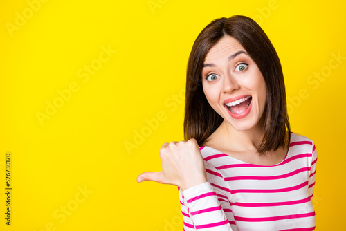 Billede på lærred Closeup photo of young crazy attractive lady looking you directing finger empty