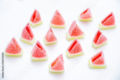 Jelly candies. Top view of watermelon jelly candies sprinkled with sugar on a blue background. Watermelon marmalade. Selective soft focus.Bright summer background.