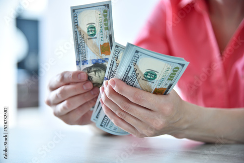 Trader woman hands counting US dollars cash in office