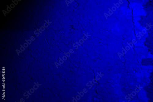 Blue neon color light on textured background.