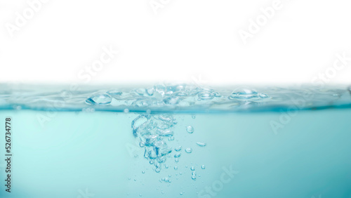 Water waves splashing with air bubbles isolated on a white background. Abstract blue water wave on white background. For product, advertisement, text space.