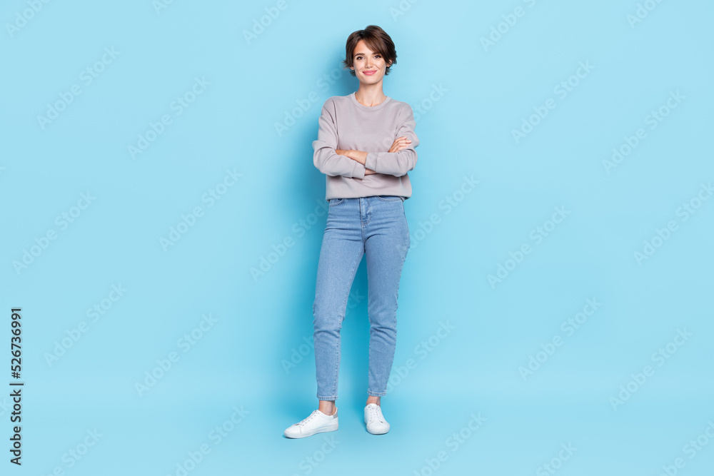 Full length photo of pretty lovely positive lady dressed trendy outfit shoes clothes arm folded isolated on blue color background Full length photo of pretty lovely positive lady dressed trendy outfit shoes clothes arm folded isolated on blue color background