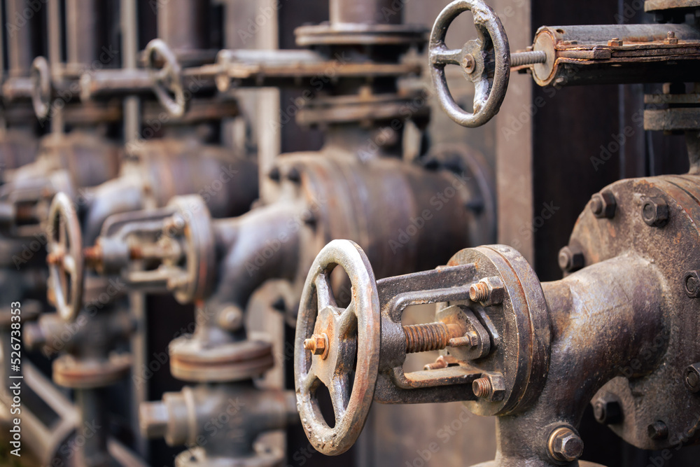 Industrial machinery background with pipes and valves. Copper, rust blur. Industrial machinery background with pipes and valves. Copper, rust blur.