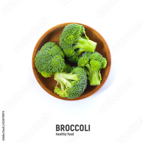 Broccoli in wooden bowl, isolated on white background, top view.