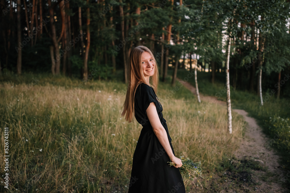 beautiful young girl in black dress and with long hair is resting in nature beautiful young girl in black dress and with long hair is resting in nature