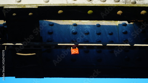 Red padlock on the iron structures of the bridge