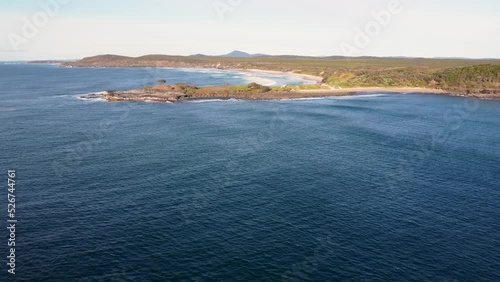 Drone aerial pan sea shot of Island headland coastline surf spot Yamba Angourie travel tourism nature landscape scenery North Coast Australia 4K