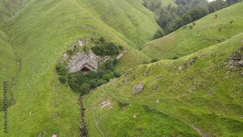 Prehistoric, Arpea Cave, on a cold misty day hidden amongst bright green hills. photo