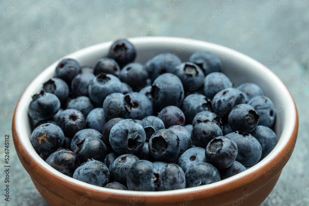 fresh ripe blueberries in bowl on table close up. banner, menu, recipe place for text, top view fresh ripe blueberries in bowl on table close up. banner, menu, recipe place for text, top view