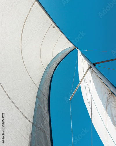a sail filled with wind. fabric sail. view of the raised sail of the ship