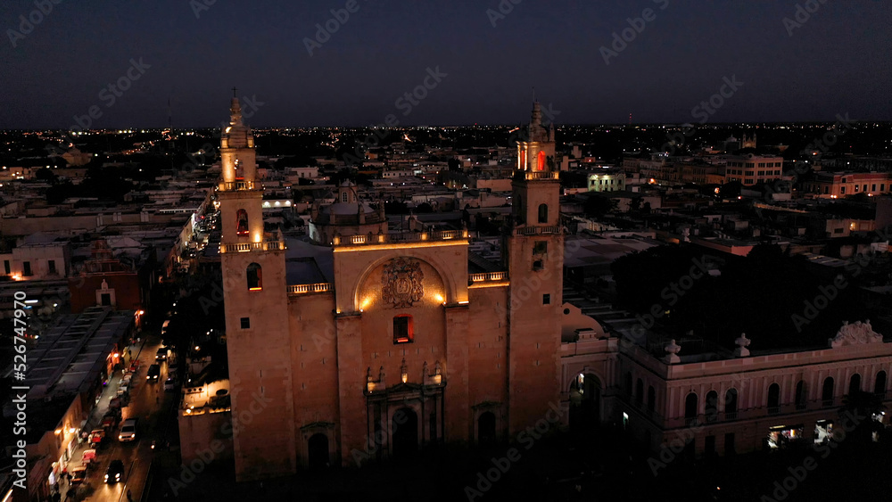 Aerial camera at night showing the Cathedral of Merida, Yucatan, Mexico at night with lights.