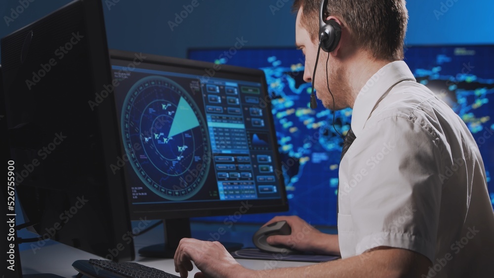 Workplace of the professional air traffic controller in the control tower. Caucasian aircraft control officer works using radar, computer navigation and digital maps. Aviation concept. Workplace of the professional air traffic controller in the control tower. Caucasian aircraft control officer works using radar, computer navigation and digital maps. Aviation concept.