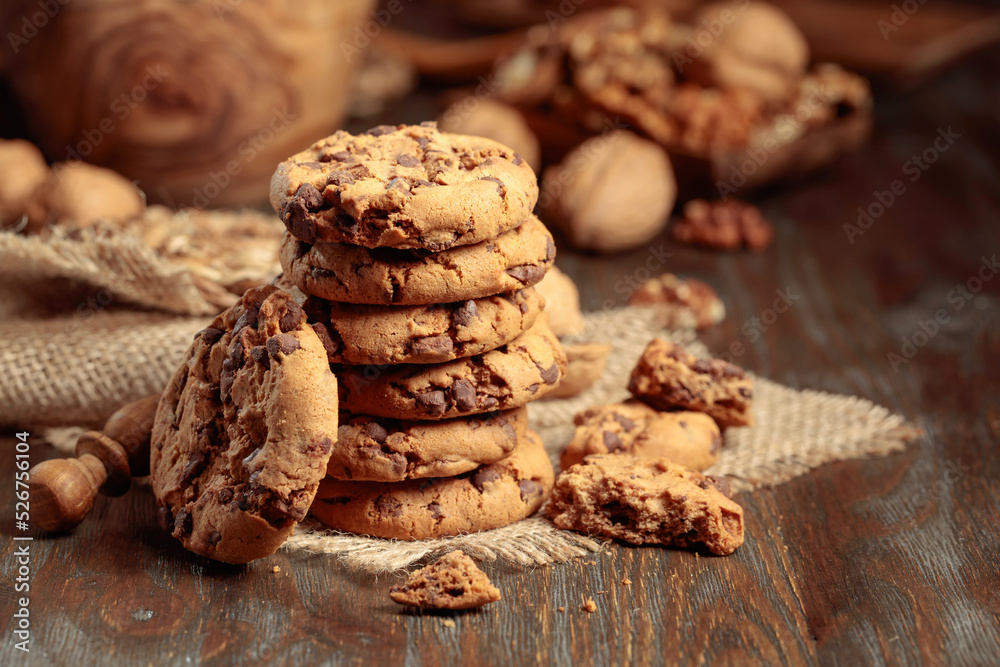 Chocolate cookies on a wooden table with kitchen utensils. Chocolate cookies on a wooden table with kitchen utensils.
