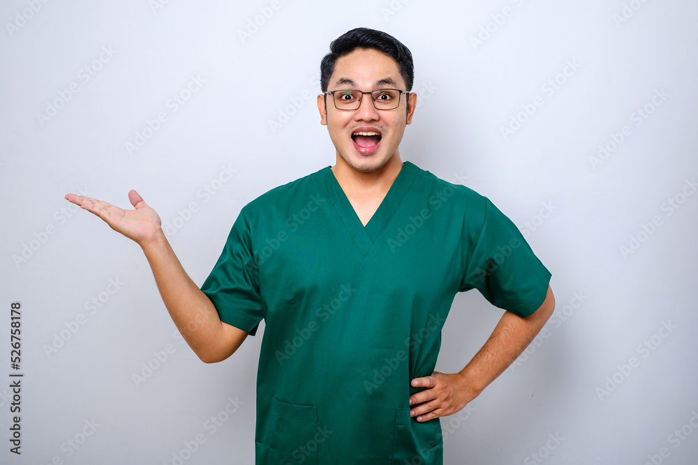 Fototapeta premium Portrait of young asian male medical worker wearing medical gear on white background