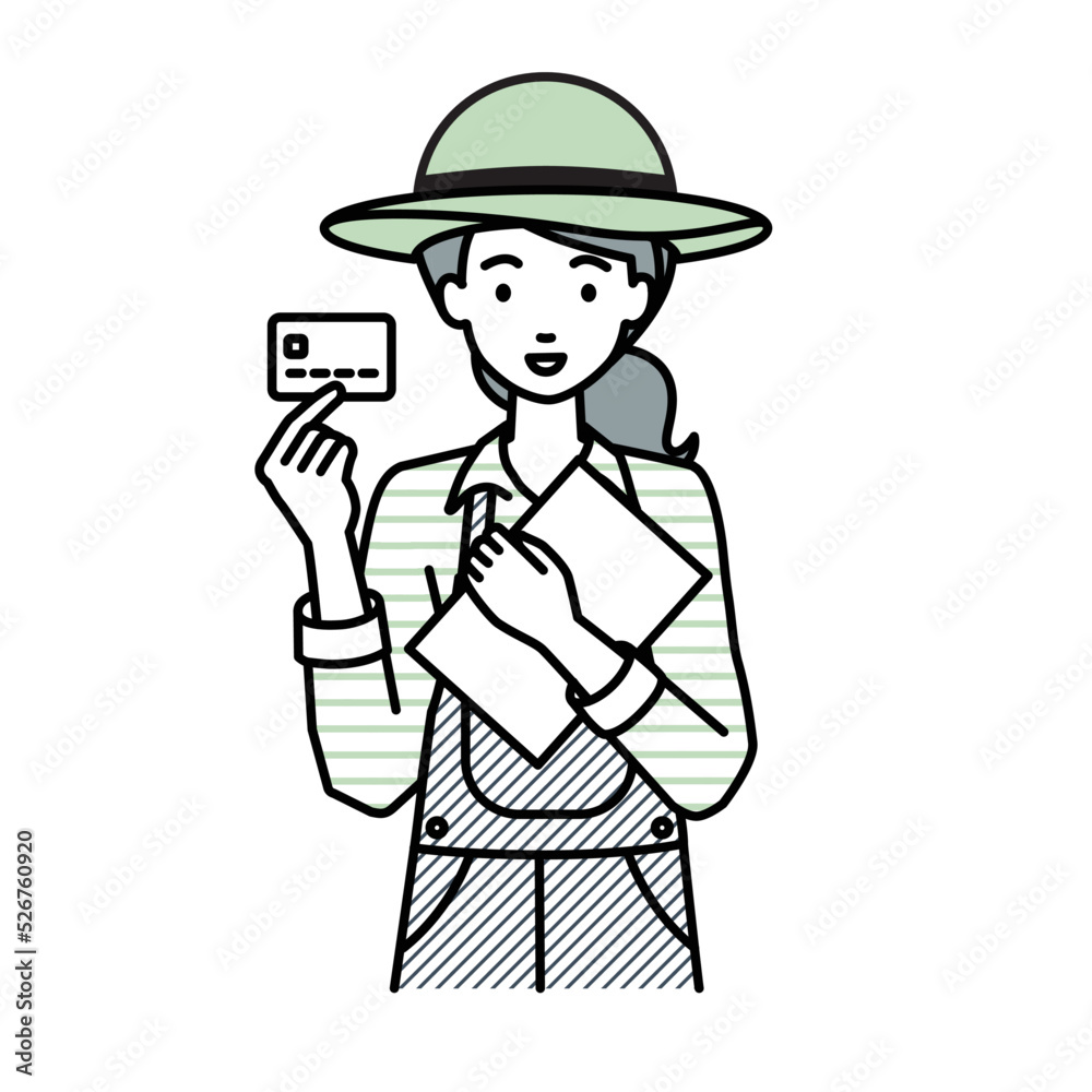 立って書類とカードを手に持つ農家の女性