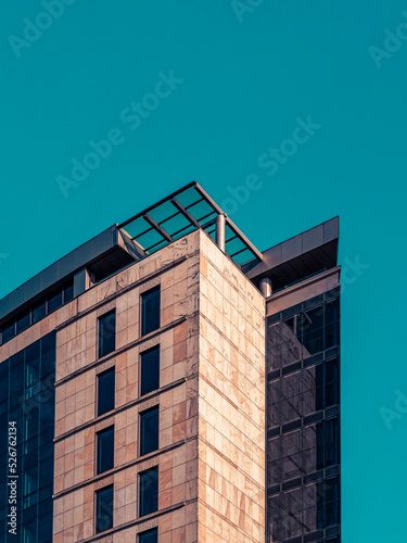 Turquoise sky and modern office building in the city photo