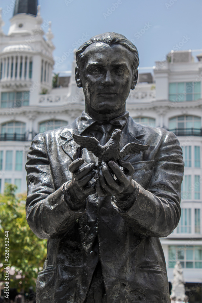 Historical statue of the famous poet, Federico García Lorca with a pigeon on Saint Anne Square (Plaza de Santa Ana) in Madrid, Spain, Europe. Old town neighborhood in the true inner city of Madrid.