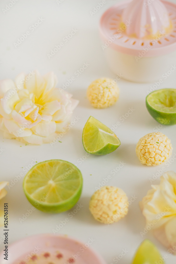 White chocolate lemon flavor candies and lemon slices on white background. Food Styling. Spring and Summer comfort food.
