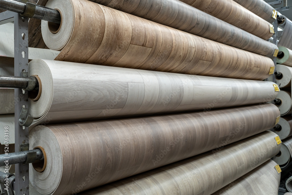 Rolls of new linoleum on the window of a hardware store. A large selection of linoleum Rolls of new linoleum on the window of a hardware store. A large selection of linoleum