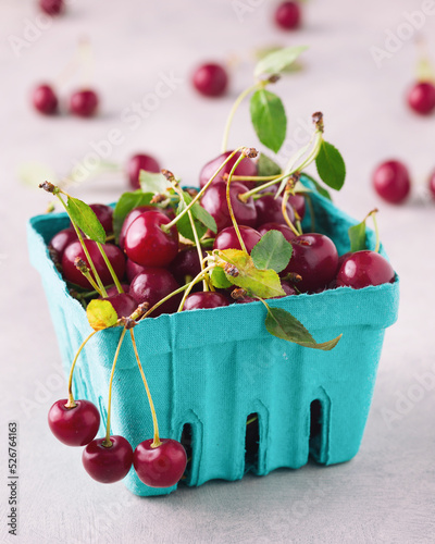 Ripe cherries in a blue punnet photo