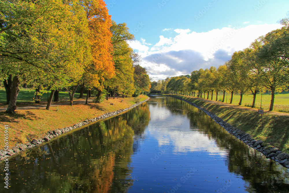 A beautiful autumn landscape with trees and lake. Park canal in autumn fall season, Stockholm, Sweden. Autumn reflections.