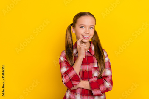 Photo of funky thoughtful schoolkid dressed plaid shirt finger lips looking empty space isolated yellow color background