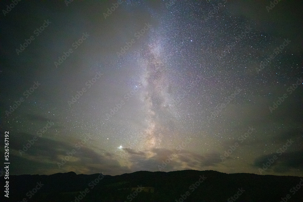 A night view of the Milky Way captured over the Bieszczady Mountains. A warm summer night.
