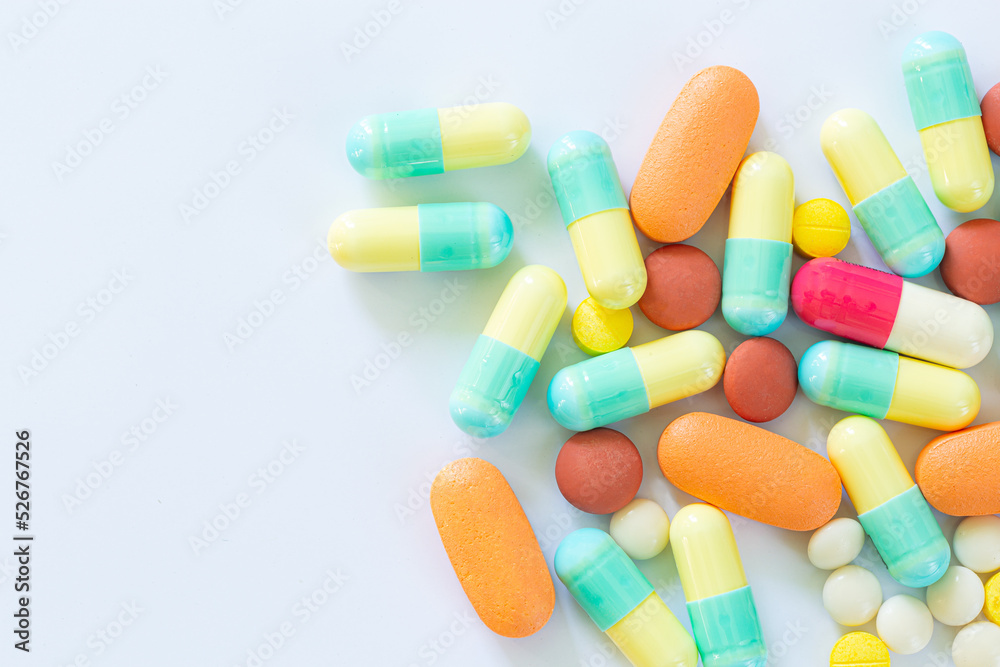 Pills and capsules on a white background,Different colorful pills on white background Pills and capsules on a white background,Different colorful pills on white background