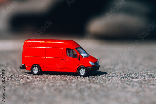 Red toy delivery van. Delivery and moving vehicle