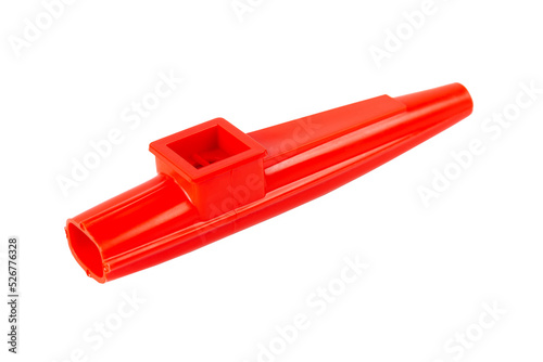 Red kazoo, plastic traditional musical instrument object isolated on white, cut out, closeup. Kids wind instruments with vibrating membrane, unique membranophones, noisemakers simple concept, nobody photo