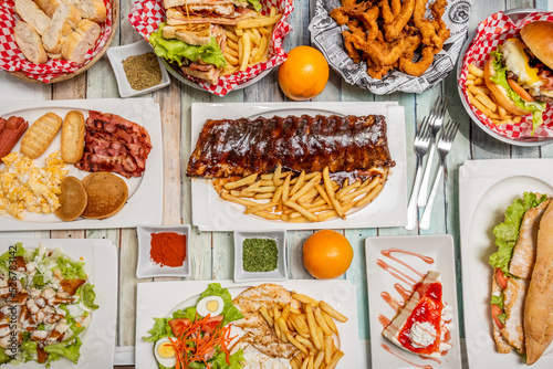 American style fast food recipes, barbecue ribs, pancakes with bacon and scrambled eggs, hamburgers, combination plate with chicken, salad and fries, cheesecake with syrup