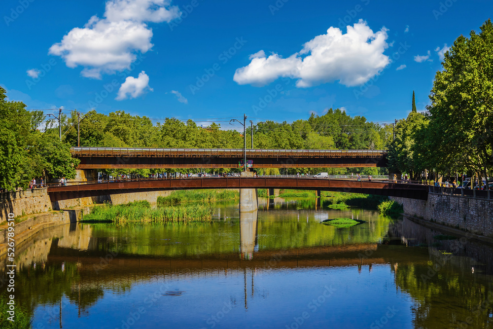Fototapeta premium City of Girona, Spain. Buildings by the river, bridge and church tower