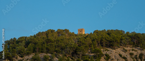 View from Pollença (Spain) of the medieval tower of Puig de Maria at sunset photo