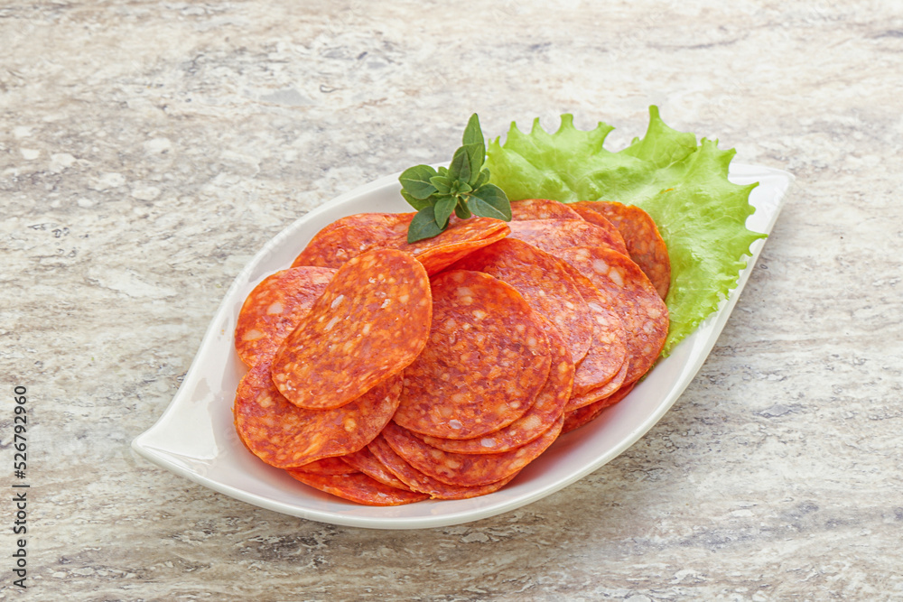 Sliced pepperoni sausage in the bowl Sliced pepperoni sausage in the bowl