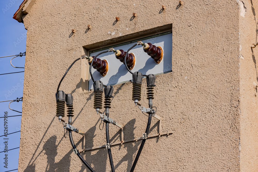 Reverse voltage on a small tower with power lines and capacitors for the electricity grid Stock