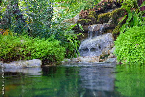 Waterfall in the park. Modern gardening. Beautiful backyard landscaping.