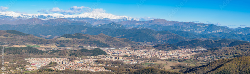 Panoramic view of Olot town and pyrenees mountains at background, Catalonia, Spain