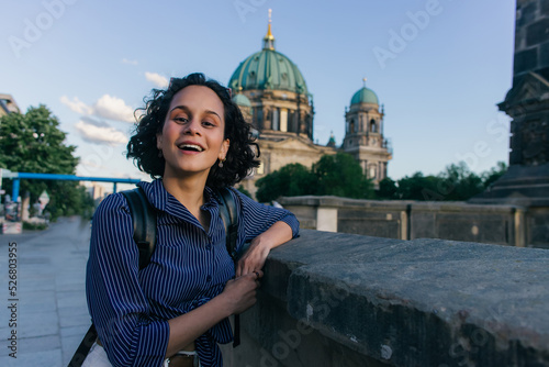 BERLIN, GERMANY - JULY 14, 2020: amazed young woman near blurred berlin cathedral.
