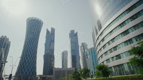 The high-rise district of Doha, seen from main avenue,  Skyscrapers and street
 photo