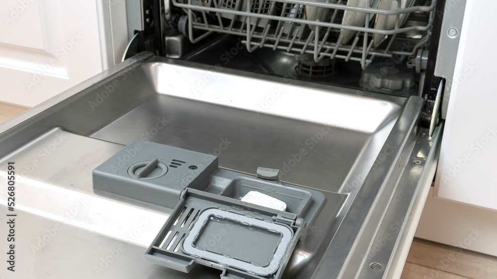 Open dishwasher with clean utensils in it Open dishwasher with clean utensils in it