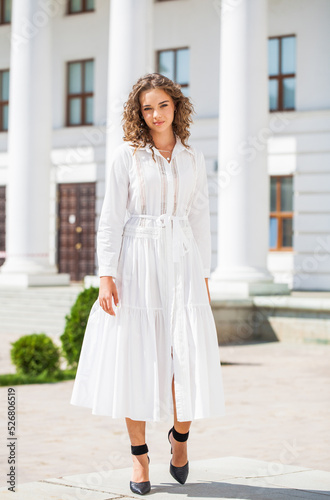 Portrait of a young woman in a white ball gown © Andrey_Arkusha